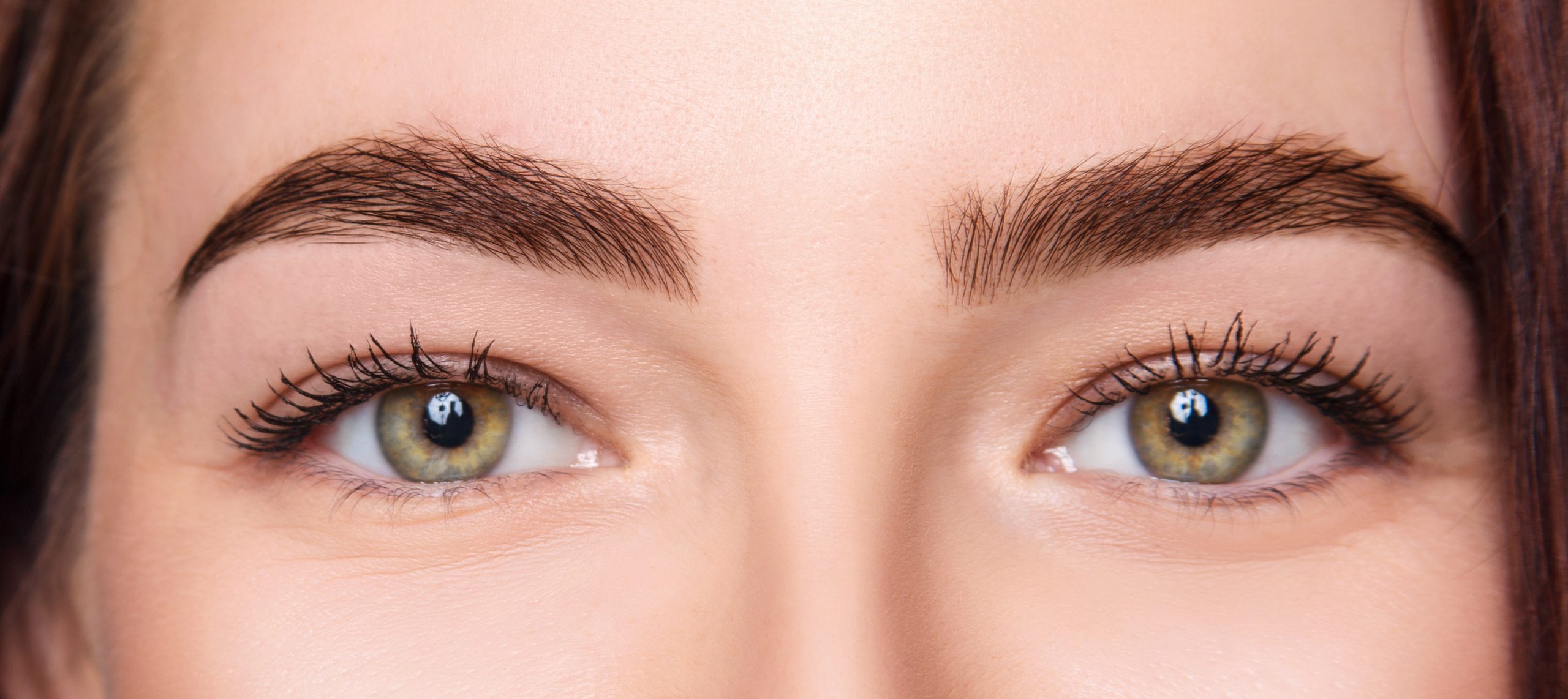 Female eyes closeup before and after eyebrows correction and dying.