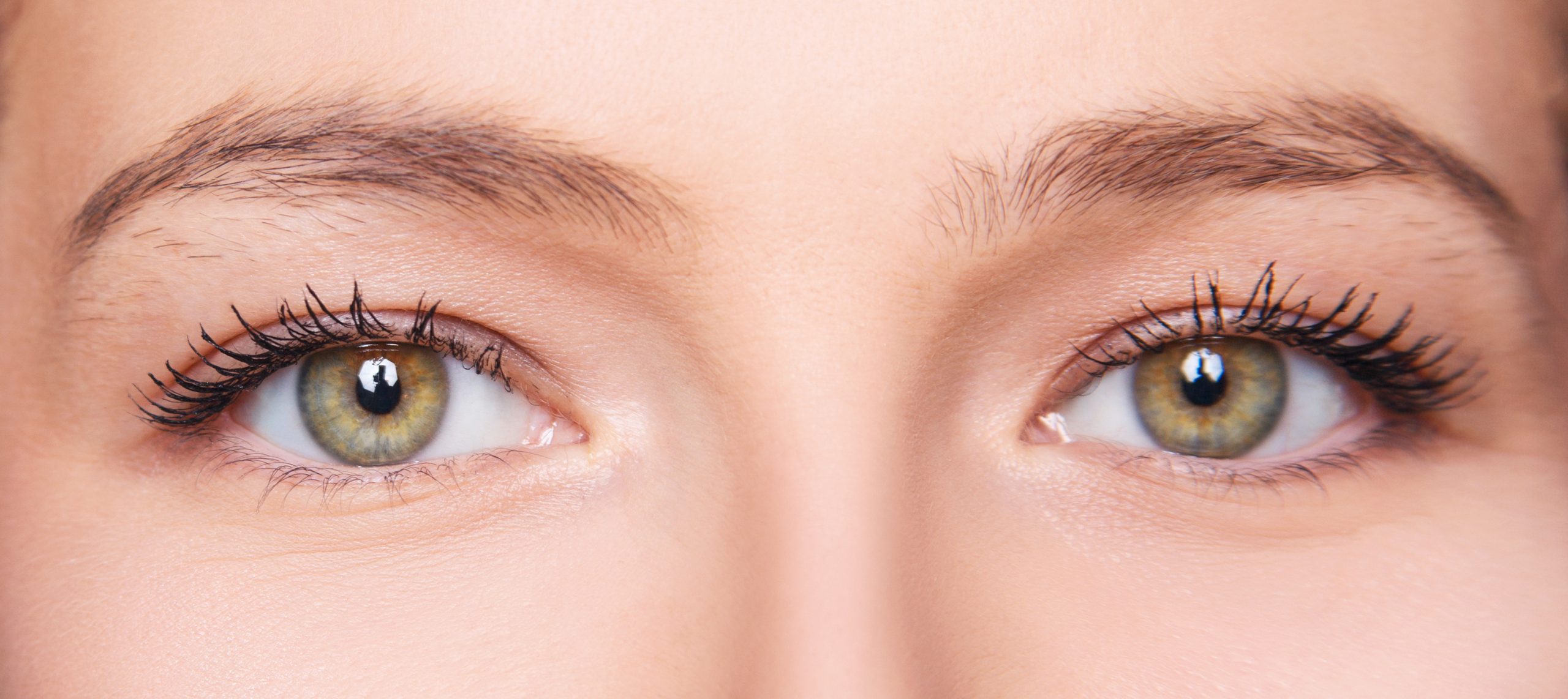 Female eyes closeup before and after eyebrows correction and dying.