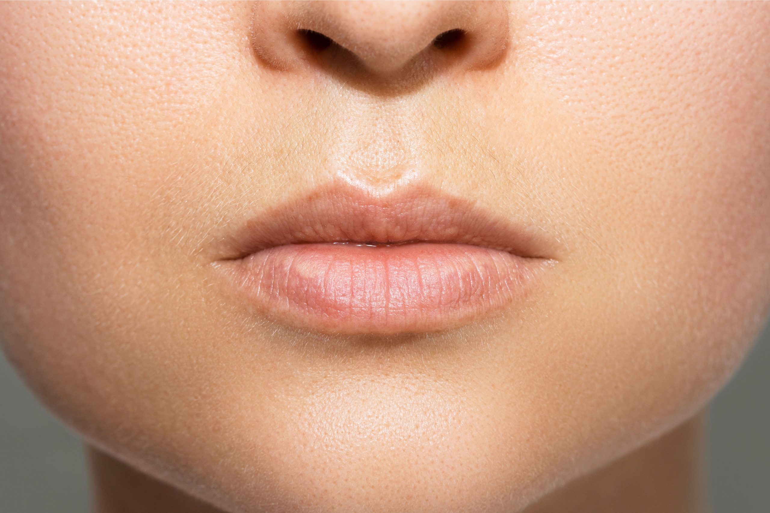 Closeup of female lips after permanent makeup lip blushing procedure